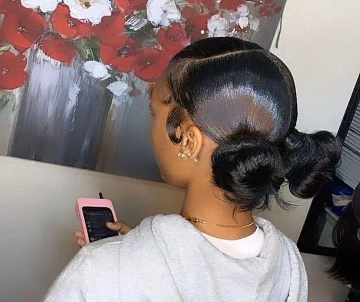 lady with short double ponytails pressing phone