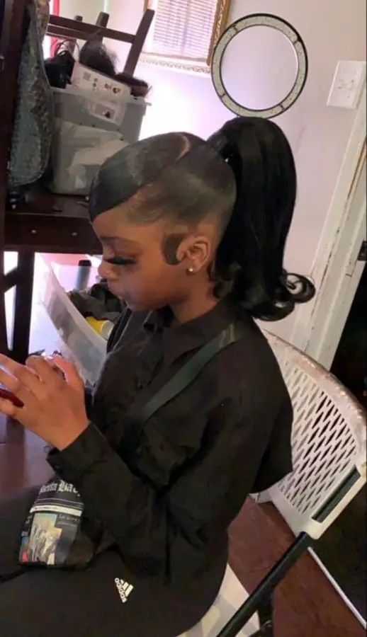 lady with medium ponytail hairstyle pressing phone