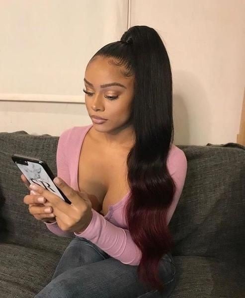 beautiful lady rocking weave ponytail and fiddling phone