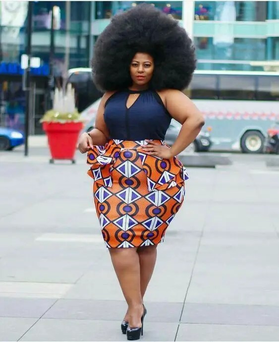 curvy lady in a colored patterned skirt and black top