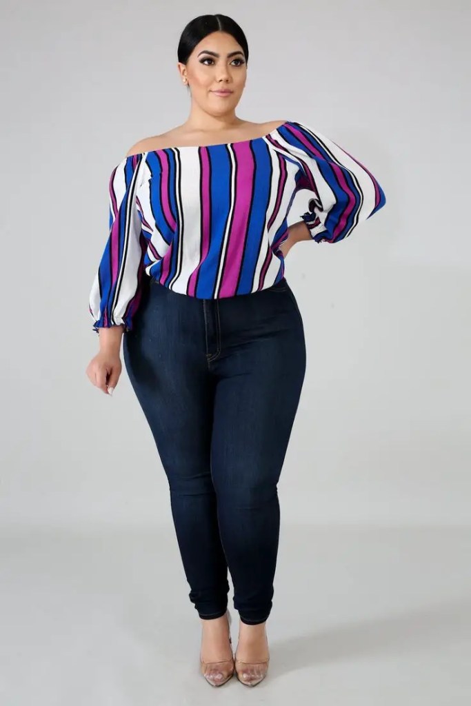 a plump lady in a loose top and black jeans