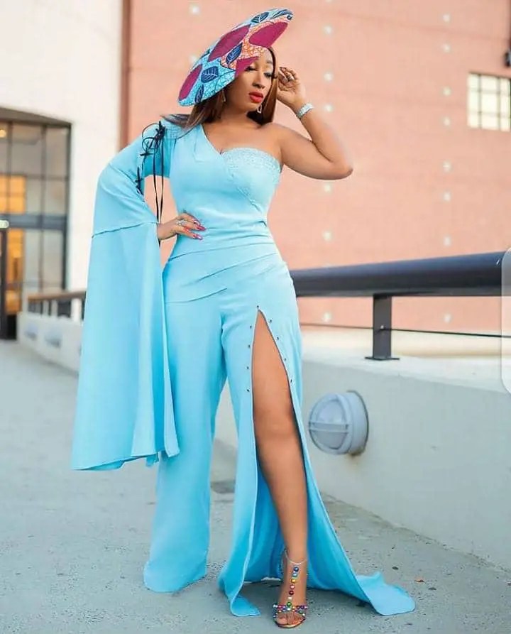 lady wearing blue jumpsuit with a hat