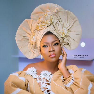 beautiful woman wearing cream gele