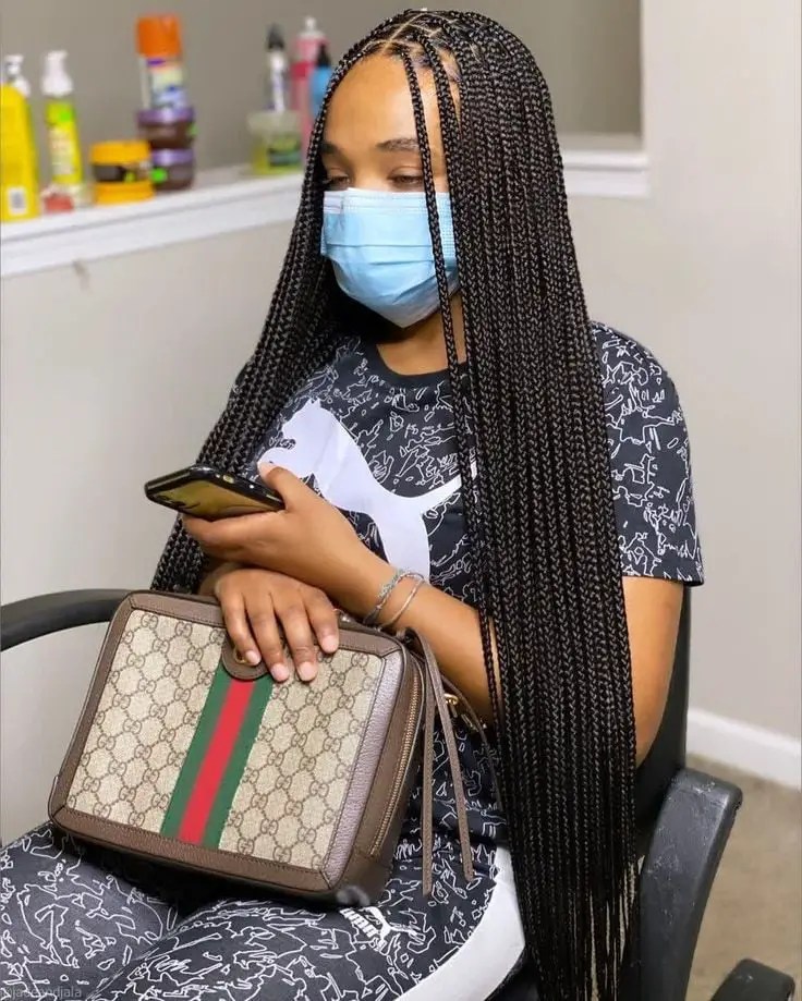 lady with facemask wearing black knotless braids