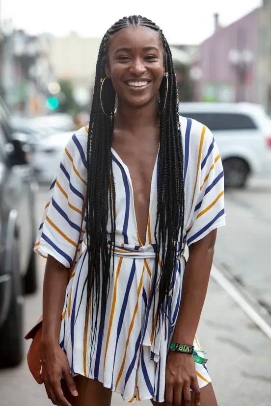 smiling lady rocking cornrows hairstyle