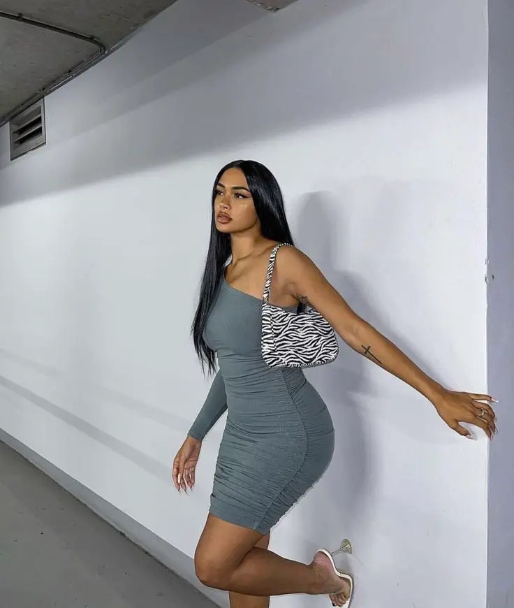 Woman wearing bodycon dress with bag and shoes