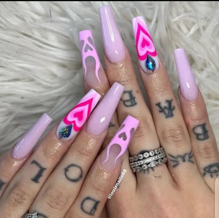 pink nails on tattooed fingers