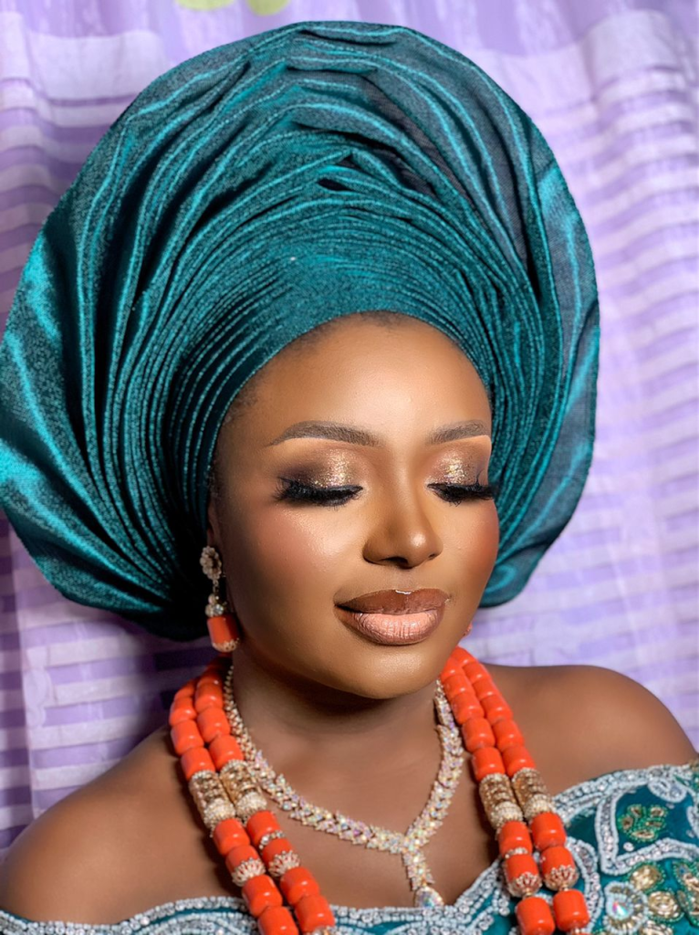 face shot of a dark lady wearing makeup for her traditional wedding