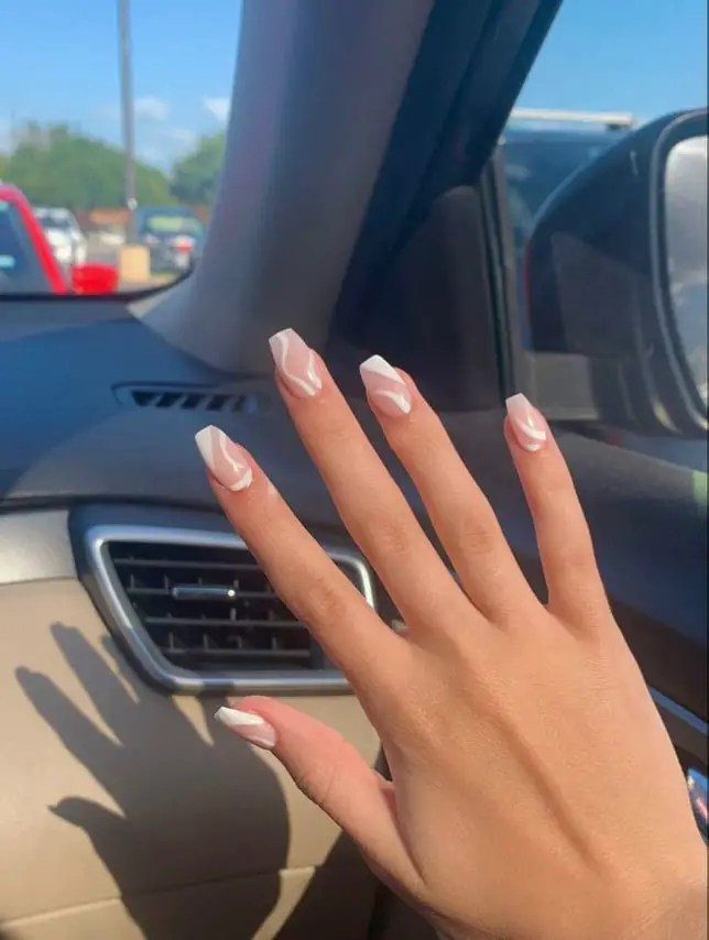 fashion nude nails on fingers inn a car