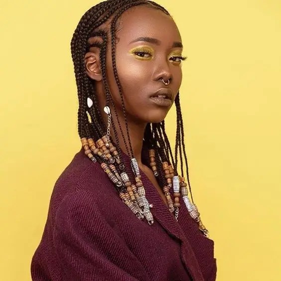 headshot of an African lady rocking Fulani braids with beads