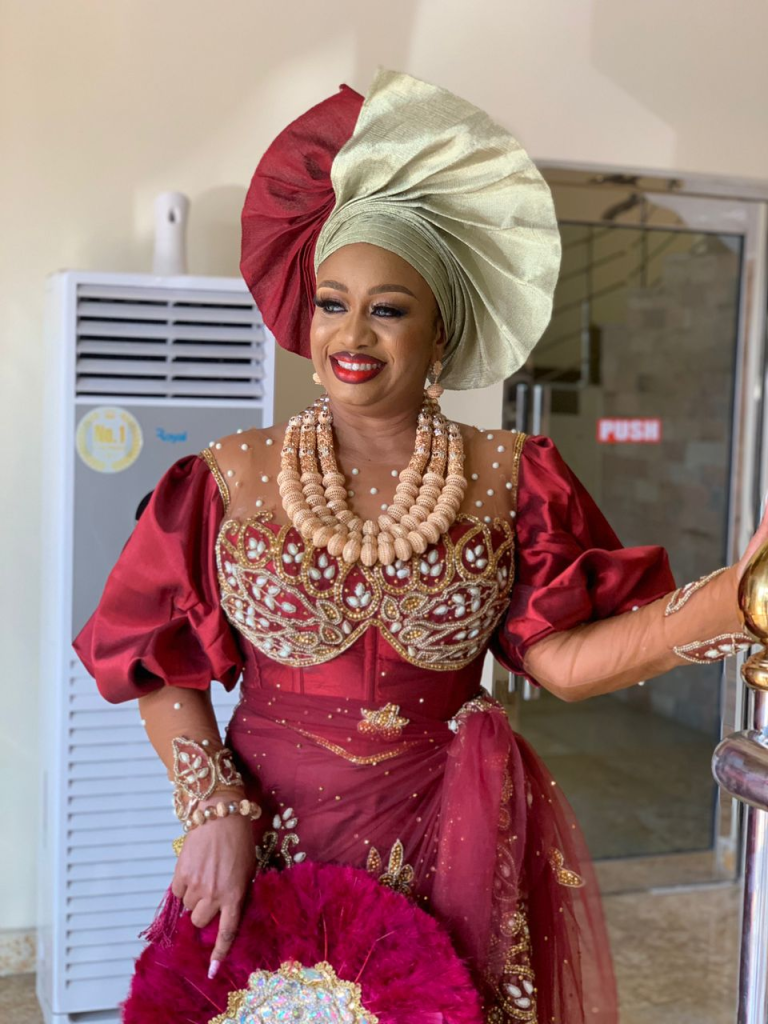smiling bride wearing makeup for her traditional wedding