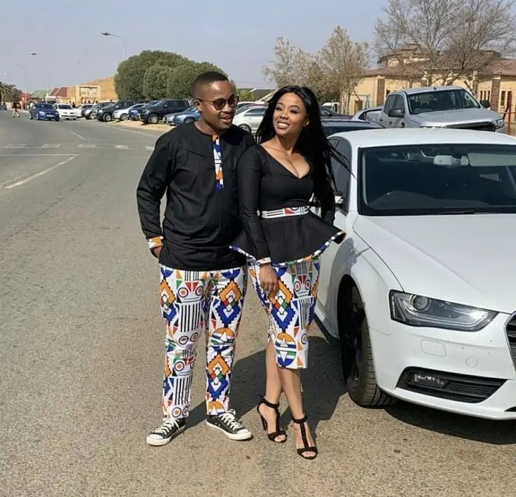 couple wearing matching ankara trousers with black tops
