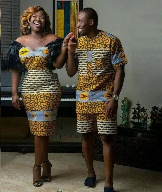 couple wearing matching casual ankara outfits posing for picture at home