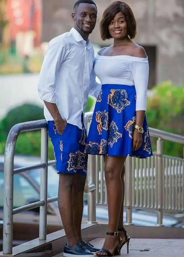 couple wearing matching ankara short bottoms with white tops
