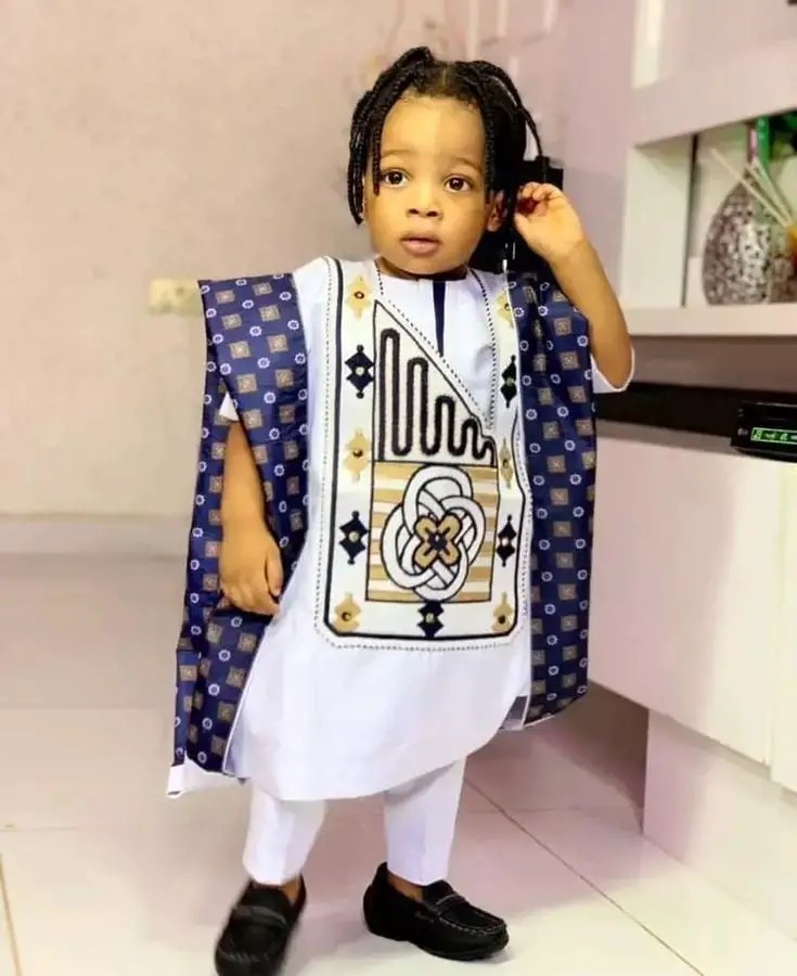 child wearing agbada and black shoes
