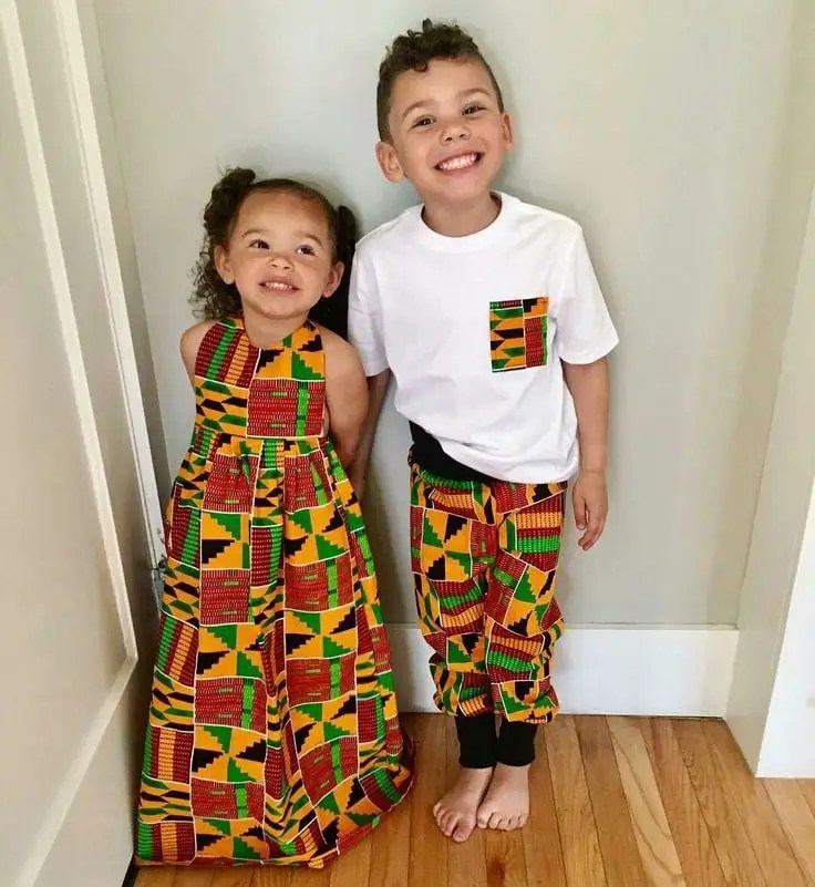 white boy and girl wearing kente fabric outfits