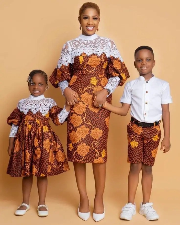 mother, daughter and son wearing matching ankara and white material outfits