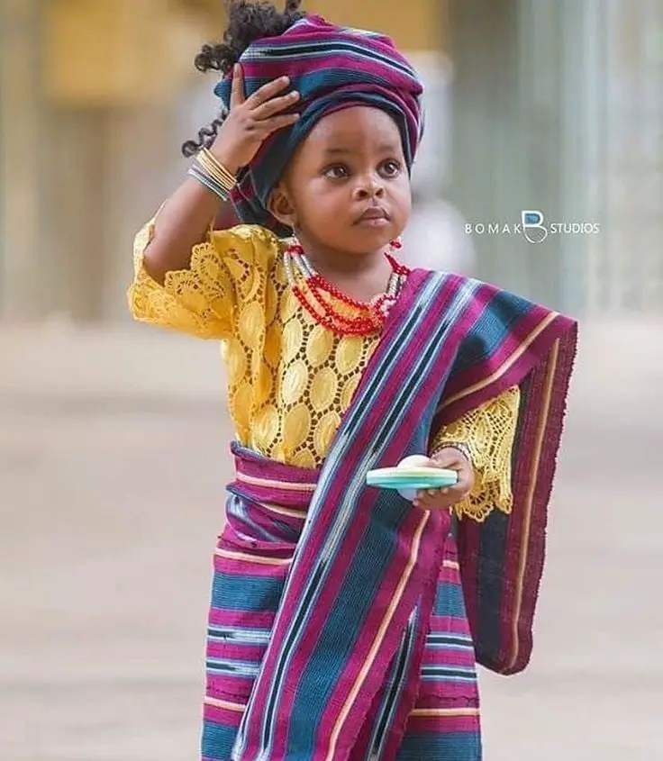 Yoruba girl wearing aso oke outfit