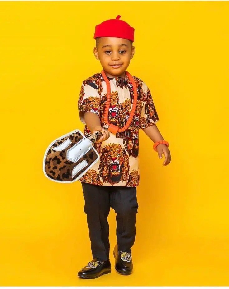 boy wearing isi agu shirt with the igbo red cap