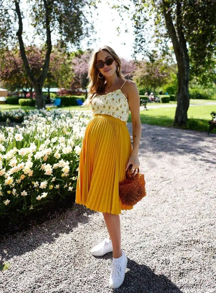 Woman wearing maternity clothes outside