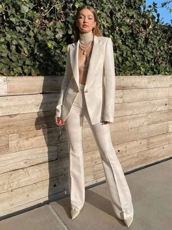lady wearing cream colored suit in the sun