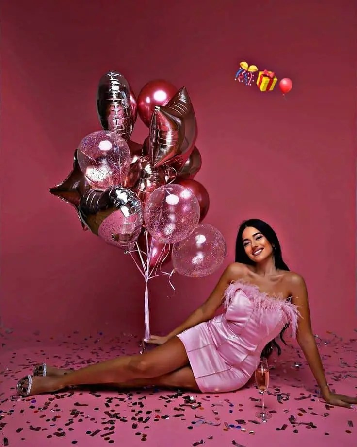 Balloons and a happy woman celebrating her birthday