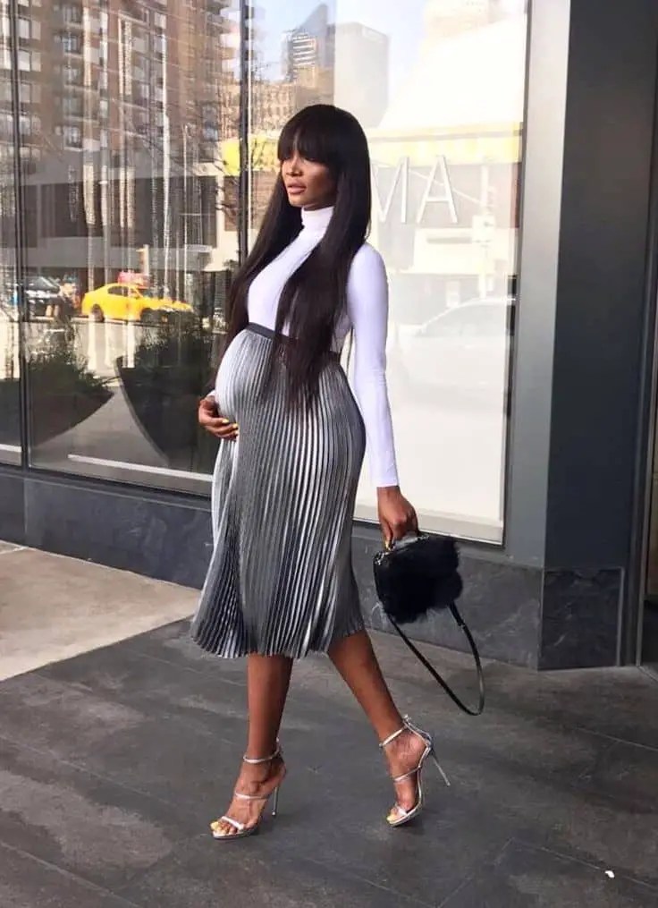 lady turtle neck and flare skirt while pregnant