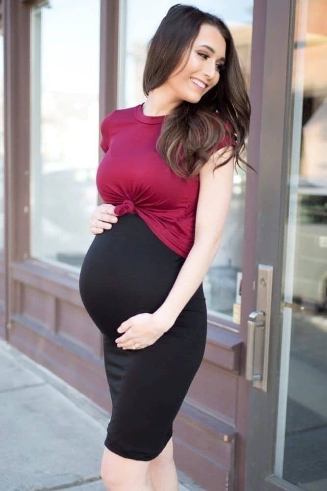 pregnant lady wearing red top with black skirt