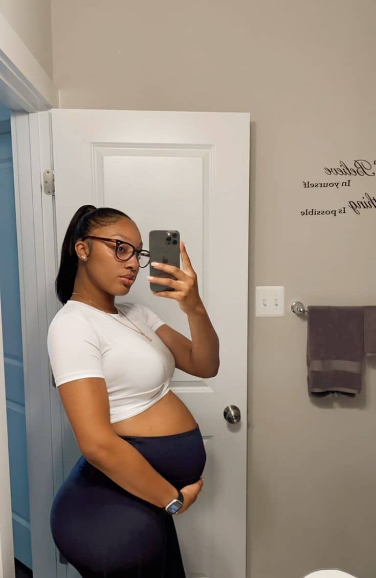 Pregnant woman wearing a white crop top