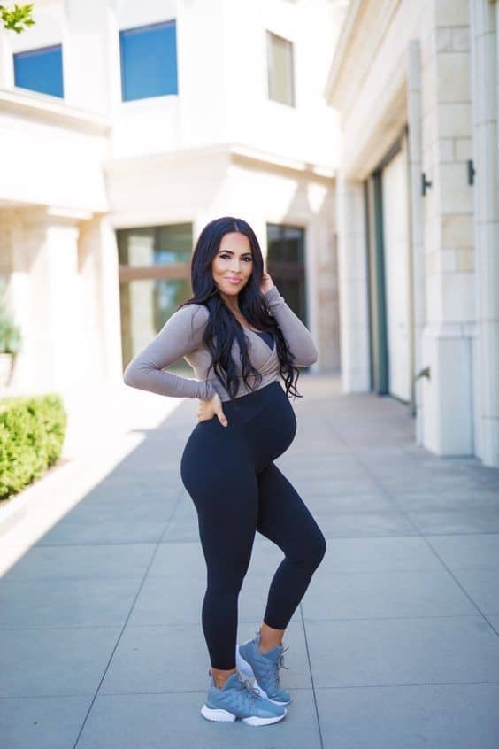Woman wearing black maternity leggings