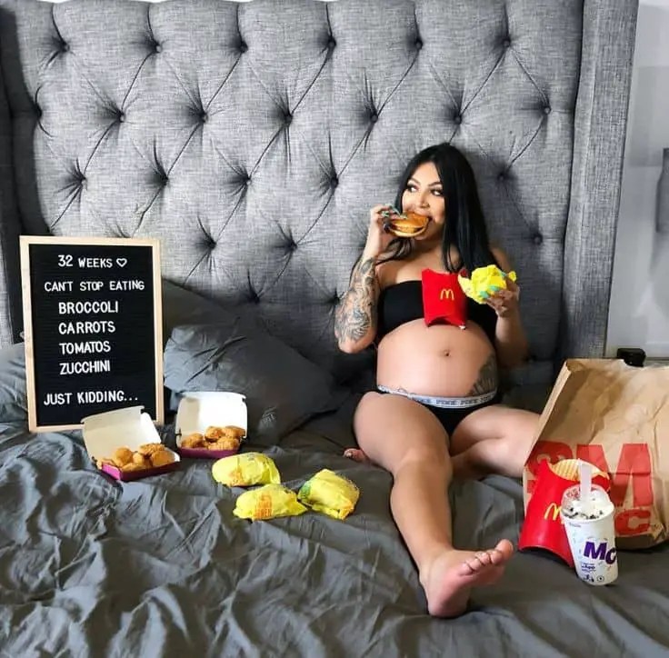 lady wearing mater underwear on bed, eating