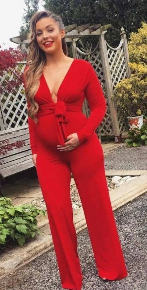 Woman wearing a red maternity jumpsuit