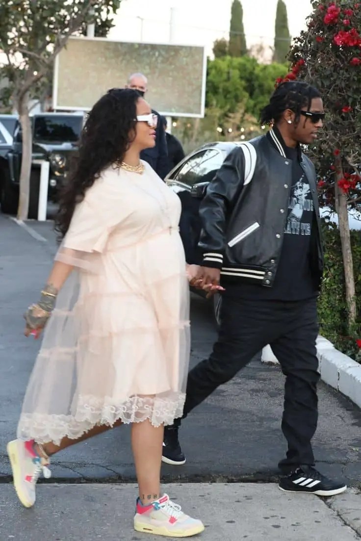 Rihanna wearing maxi maternity gown with sneakers in company of ASAP Rocky