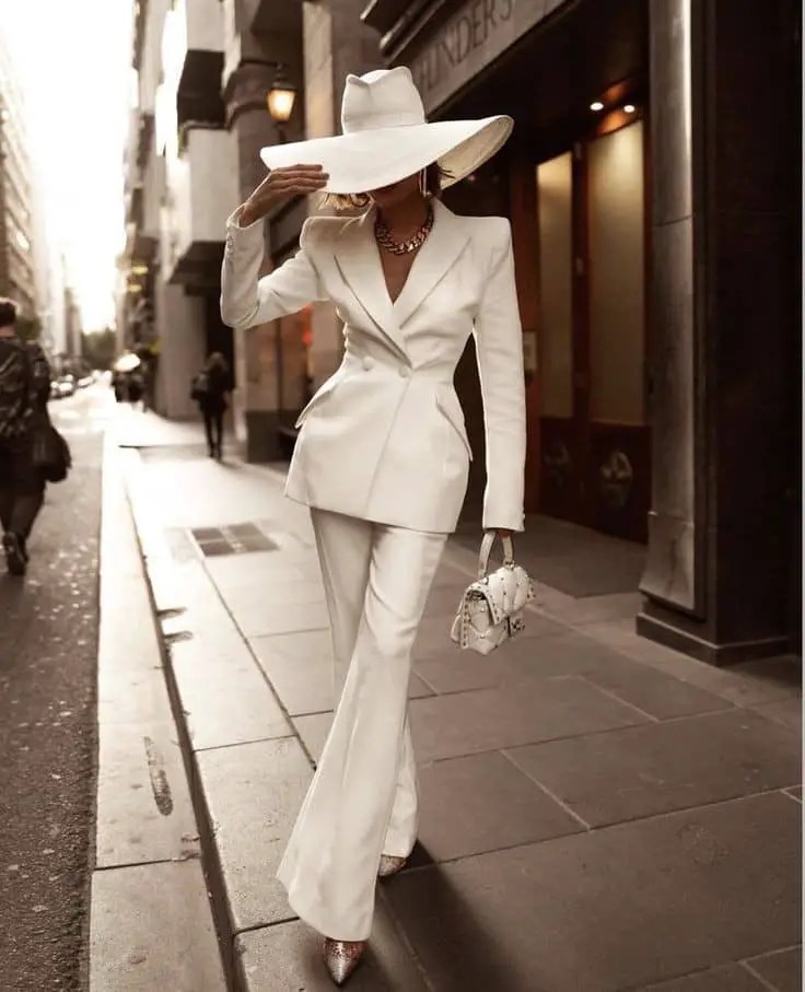 lady wearing white suit with hat