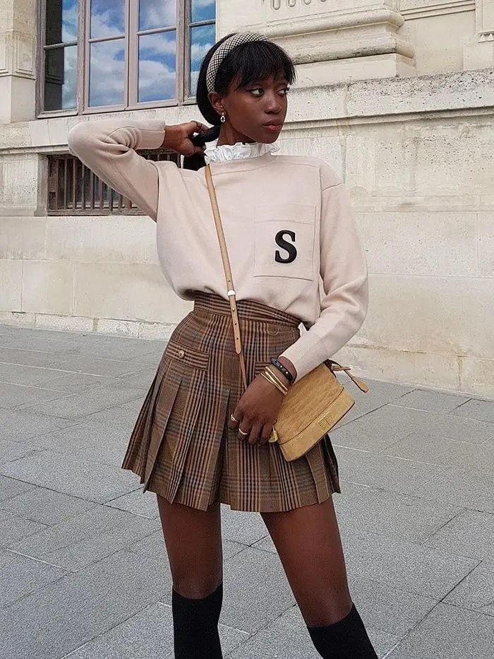 lady wearing flared skirt with knee-high boots