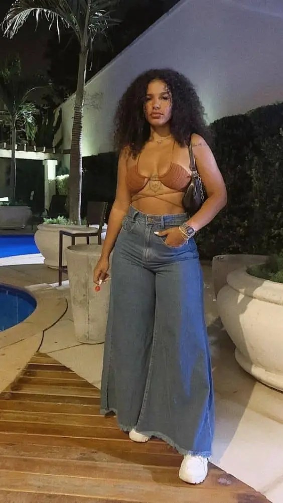 A woman wearing a bra top in Palazzo pants