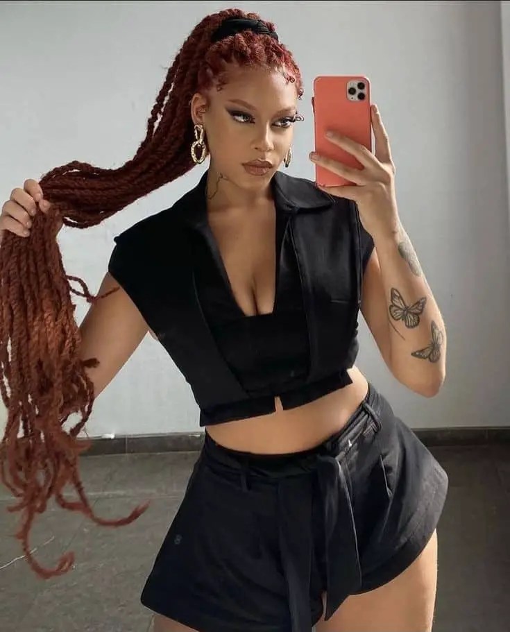 Senegalese braid woman taking a mirror selfie