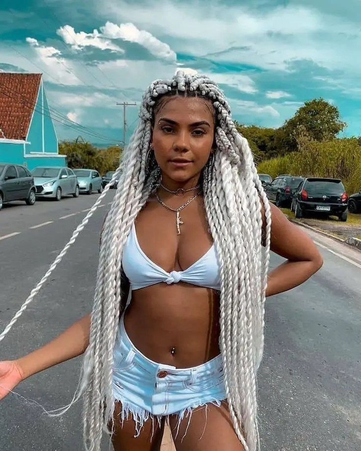 lady in hot outfit rocking white Senegalese braids