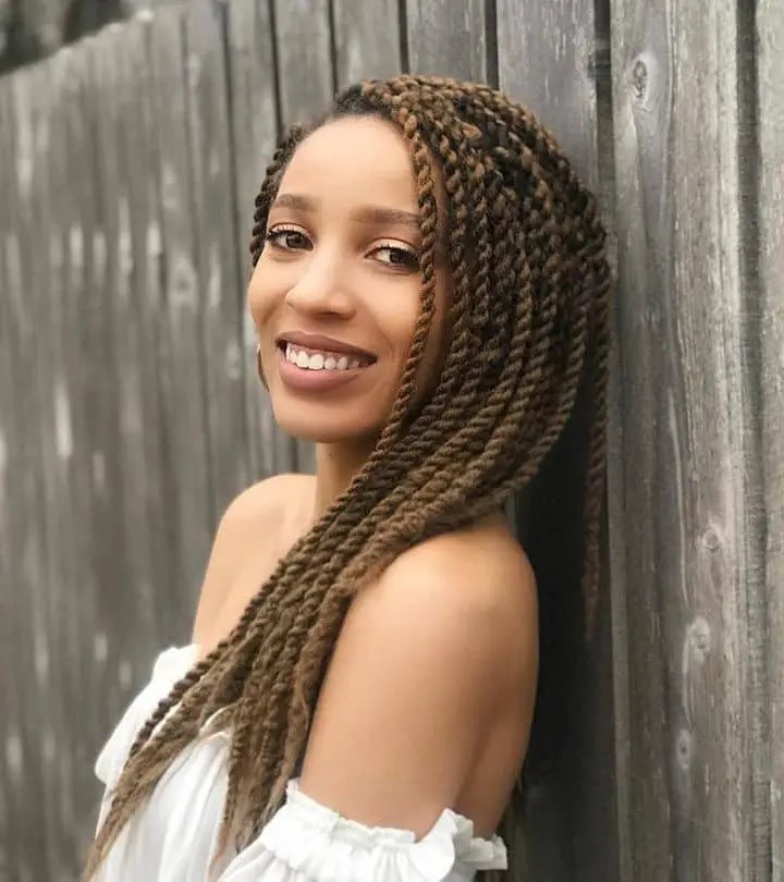 Smile of pretty woman wearing a little senegalese braid