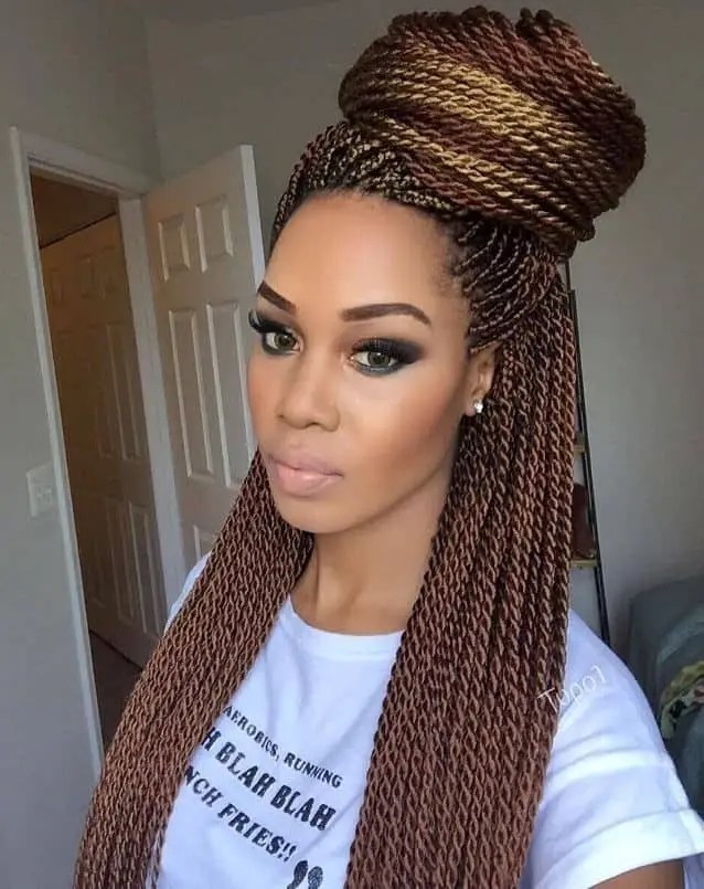 Woman wearing a small senegalese braid in updo style