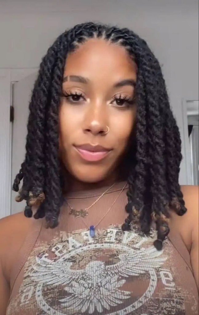 The beauty of a smile wearing a short Senegalese braid