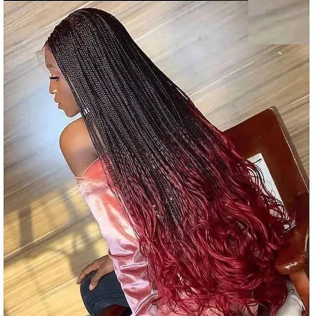A woman wearing a long little braid made of attachments