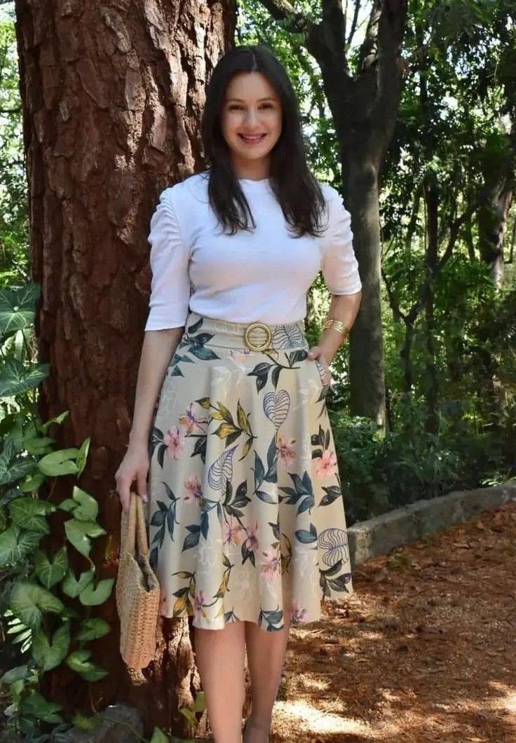 Woman wearing a white top in a floral flared skirt