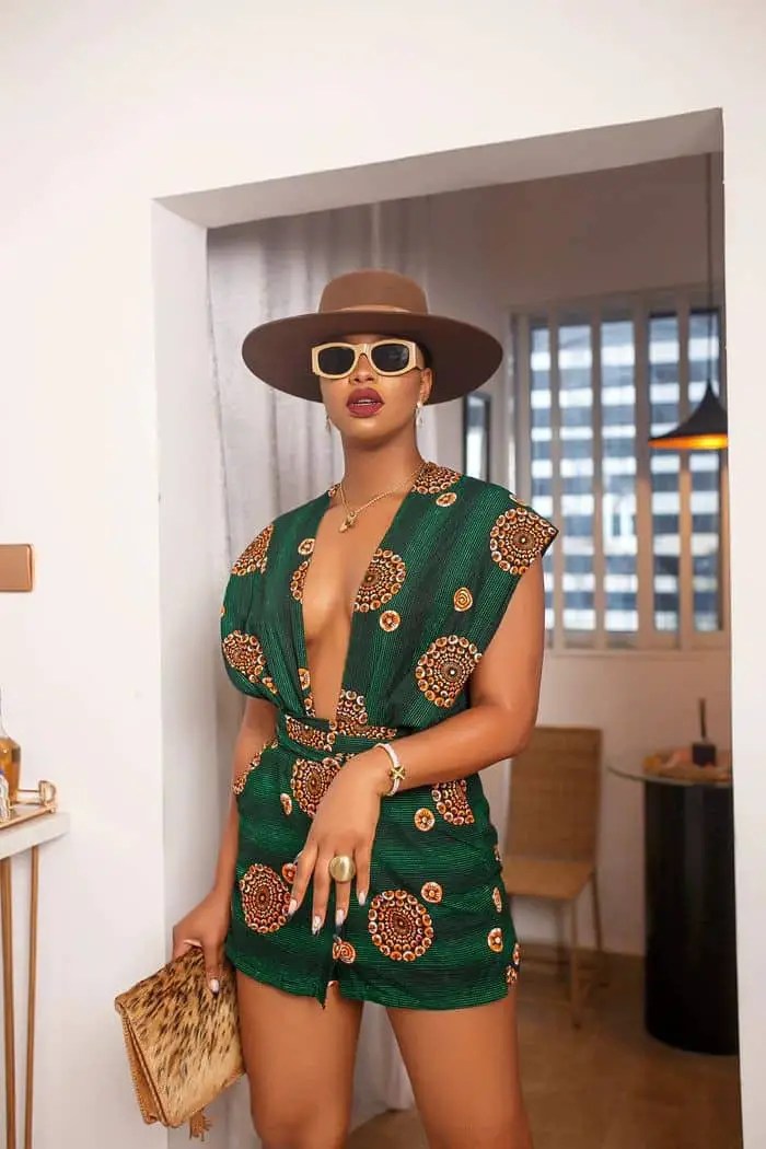 Woman wearing ankara short dress with hat and glasses