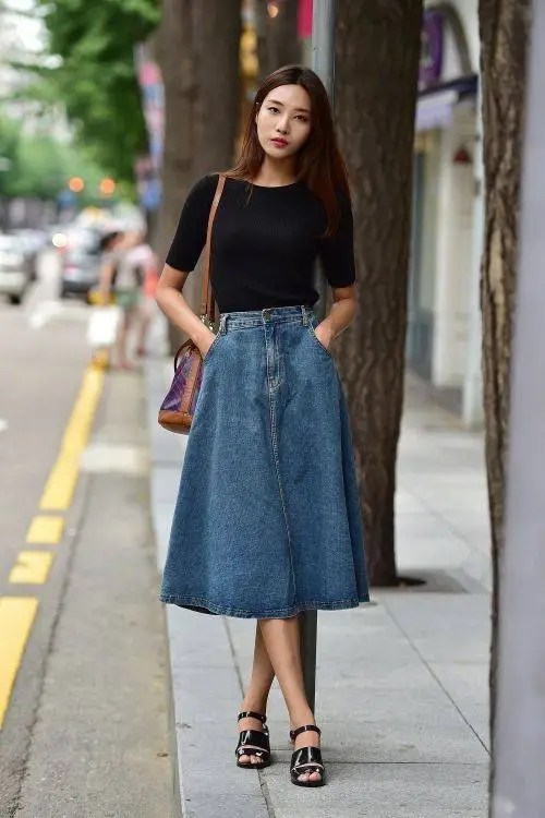 lady wearing black top with jean flared skirt