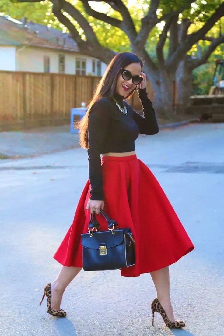 lady wearing black turtleneck top with red flared skirt