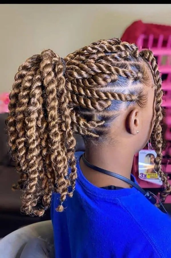 A woman wearing a large Senegalese braid \