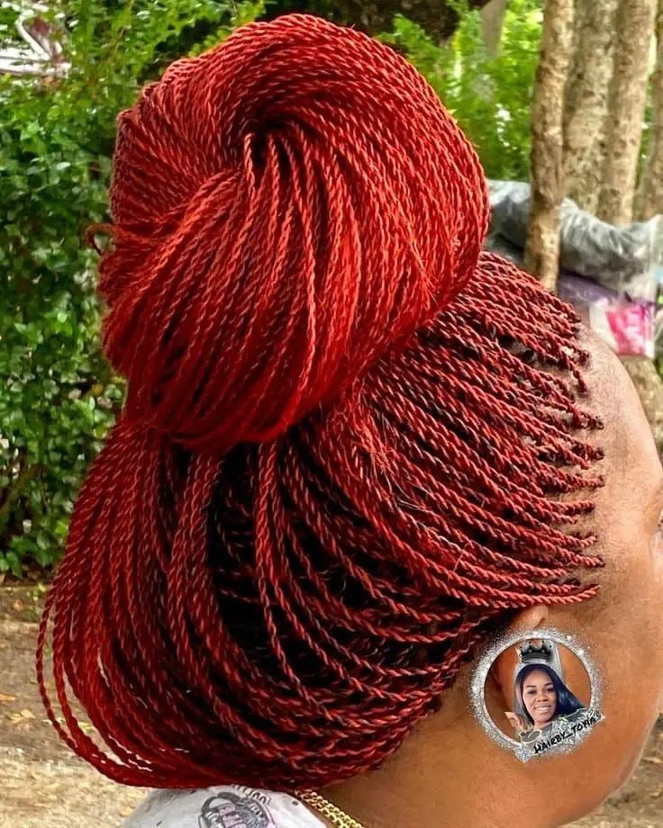 lady wearing red tiny Senegalese twists