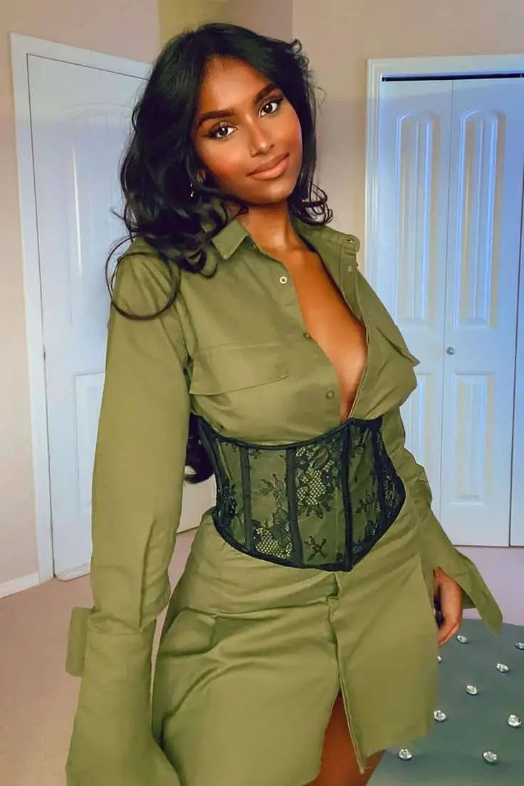 Woman wearing a black corset and army green shirt dress