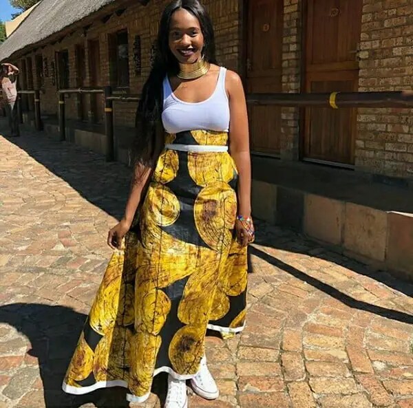 lady wearing sneakers with long flared skirt